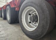 Semirimorchio rosso carrellone Goldhofer 4 assi con vasca culla allungabile e collo staccabile