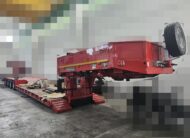 Semirimorchio rosso carrellone Goldhofer 4 assi con vasca culla allungabile e collo staccabile